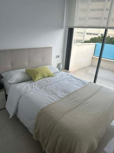 a bedroom with a large bed with a large window at Prestige Sunny Terrace Apartment - Torrevieja in Torrevieja