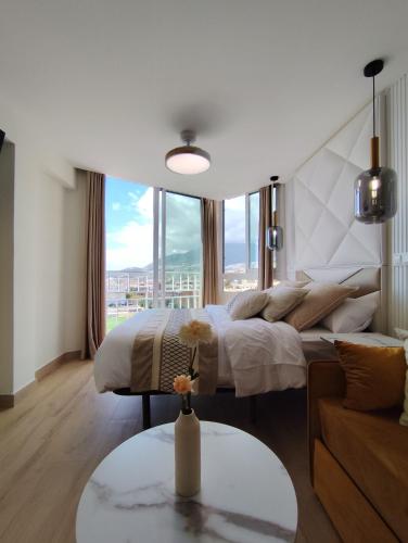 a bedroom with a large bed and a large window at Blue Piscis Studio - Piscina in Benalmádena