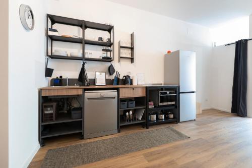 a kitchen with a counter and a refrigerator at Ospitalità Il Prato in Iesi