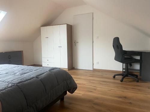 a bedroom with a bed and a desk and a chair at location appartement neuf dans maison in Aix-les-Bains