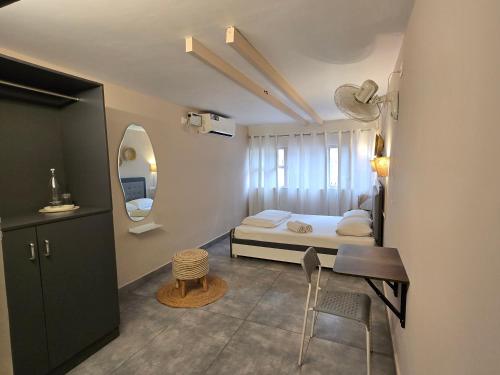 a small bedroom with a bed and a table and chair at Woke Indiranagar in Bangalore