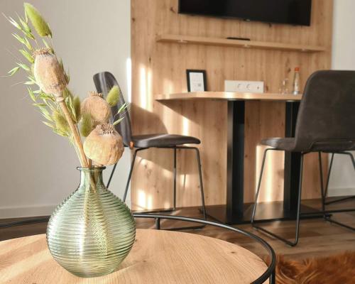 a vase with flowers in it sitting on a table at Landhotel Kachelofa in Vaihingen an der Enz