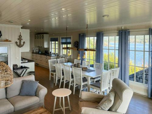 a kitchen and living room with a table and chairs at Cottage With Private Dock By Eidangerfjord in Porsgrunn