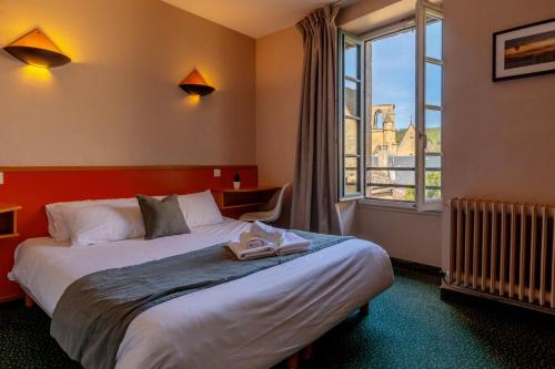 a hotel room with a large bed and a window at Hôtel des Récollets in Sarlat-la-Canéda