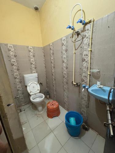 a bathroom with a toilet and a shower in it at Naimisharanya Residency in Naimishāranya
