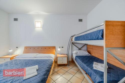 a bedroom with two bunk beds and two lamps at Residence La Rotonda in Cervia