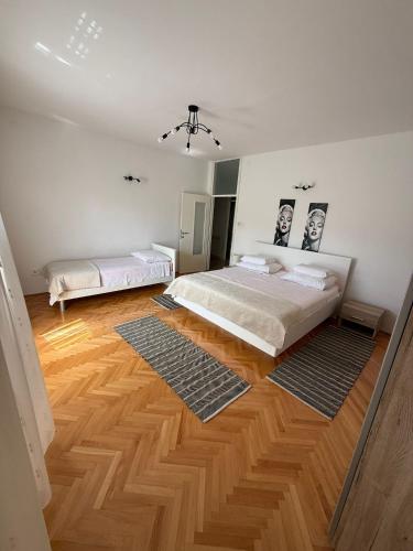 a bedroom with a bed and a wooden floor at Villa Brajković in Vodice