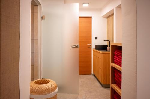 a bathroom with a toilet with a stool in it at Soami Spaces - Alpine Hideaway in Millstatt