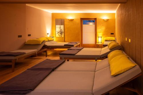 a room with several beds in a row at Soami Spaces - Alpine Hideaway in Millstatt