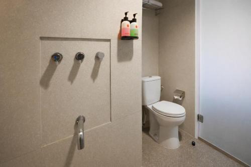 a bathroom with a toilet and a shower stall at Amaris Hotel Bekasi Barat in Bekasi