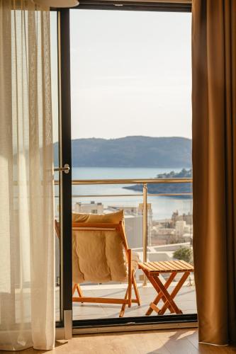 a room with a balcony with a view of the water at The Dream Getaway & Spa by DeVasco in Bečići