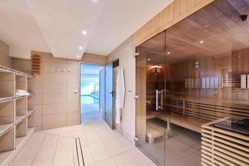 a bathroom with a walk in shower and a glass door at Nautic - 307 in Cuxhaven