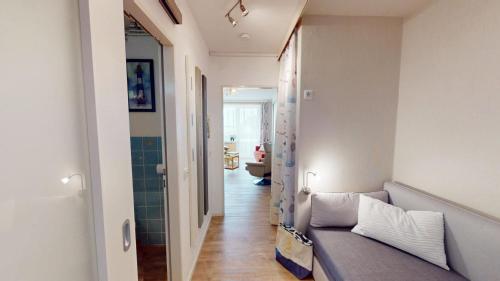 a living room with a couch and a hallway at Nautic - 307 in Cuxhaven