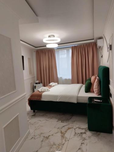 a bedroom with a large bed with a marble floor at studio lipscani Old Town Center in Bucharest