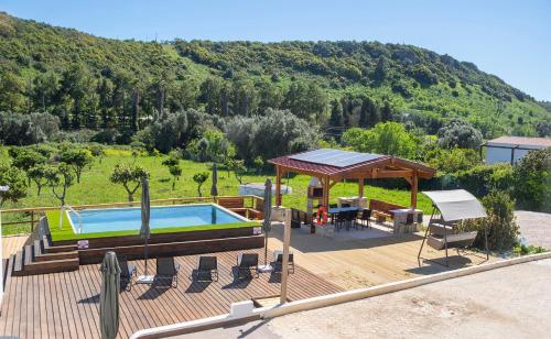 a deck with a pool and a gazebo at Quinta Silvestre in Bensafrim