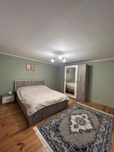 a bedroom with a bed and a rug at Lankaran Boutique Home in Lankaran