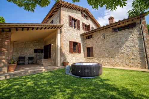 a garden with a large barrel in front of a building at Scappo in Umbria, La dolce Godera in Lugnano in Teverina