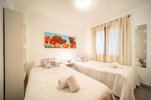 a bedroom with two beds with white sheets at Piso Marc by Sealand Villas in Port de Pollensa