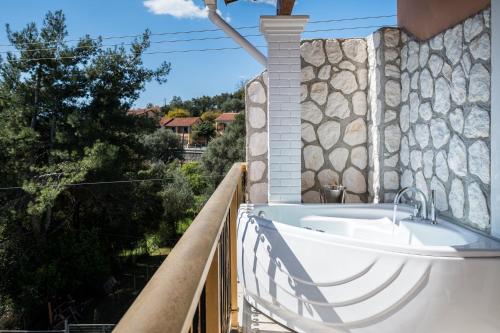 a bath tub on the side of a building at Aloe Seaview Apartments with Private Spa Tub by Konnect in Dassia