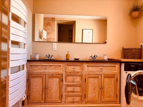 a bathroom with a sink and a mirror at La Bastide des Dentelles in Roaix
