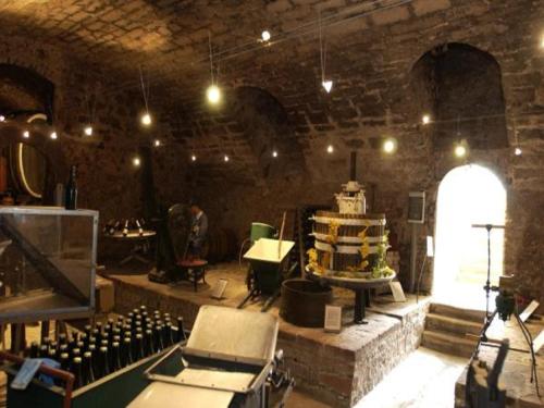 a large room with a stage with a bunch of wine bottles at Hotel Goldbächel in Wachenheim an der Weinstraße