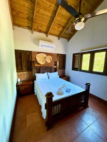 a bedroom with a large bed with a wooden ceiling at Casa Del Cielo in Jarabacoa