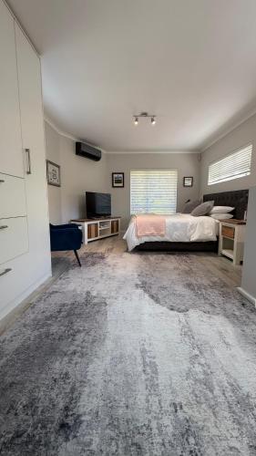 a bedroom with a bed and a television in it at Hack's Shack in Cape Town