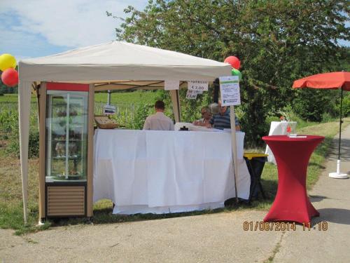 a white tent with people sitting at a table at Hotel Goldbächel in Wachenheim an der Weinstraße