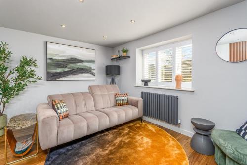 a living room with a couch and a rug at The Castle Suite 24h Gym Free Parking in Kenilworth