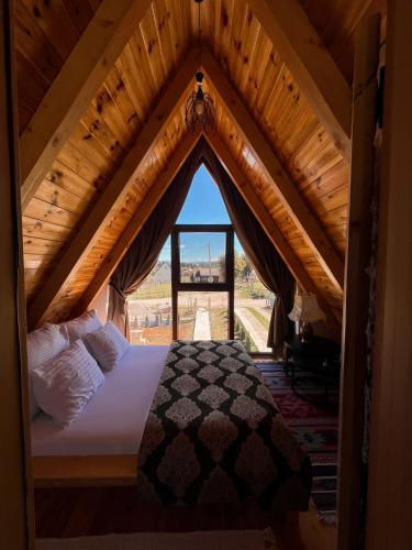 a bedroom with a bed in a wooden attic at Guest House Sara 2 in Žabljak