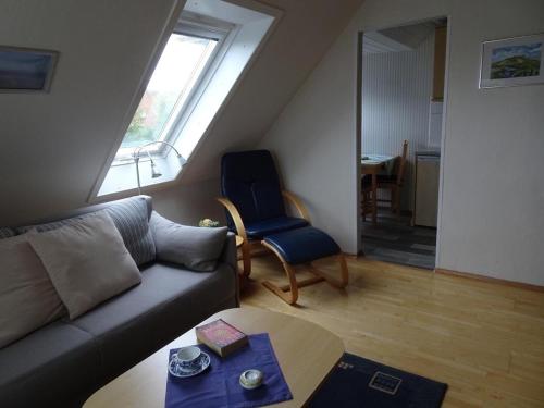 a living room with a couch and a chair at Pidder Lyng - FW 3 in Utersum