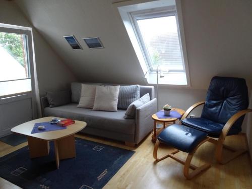a living room with a couch and a chair at Pidder Lyng - FW 3 in Utersum