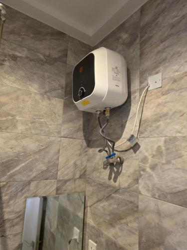 a paper towel dispenser on a tile floor at BJ Home in Iseri-Oke