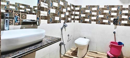 a bathroom with a sink and a toilet at RUDRAKSH HOTEL & RESTAURANT in Kumbhalgarh in Kumbhalgarh