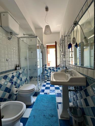 a bathroom with a toilet and a sink and a shower at Ketty's House in Vico Equense