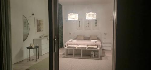 a bedroom with a bed and two chandeliers at Villa Eura in Pula