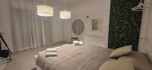 a bedroom with a large bed with two towels on it at Villa Eura in Pula