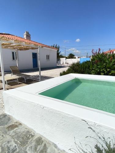 a swimming pool in front of a house at Mileu slowhouse in Veiros