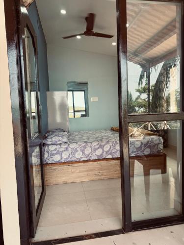 a bedroom with a bed and a mirror at Stay by the Backwater in Kalyānpur