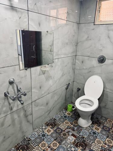 a bathroom with a toilet and a shower at Stay by the Backwater in Kalyānpur