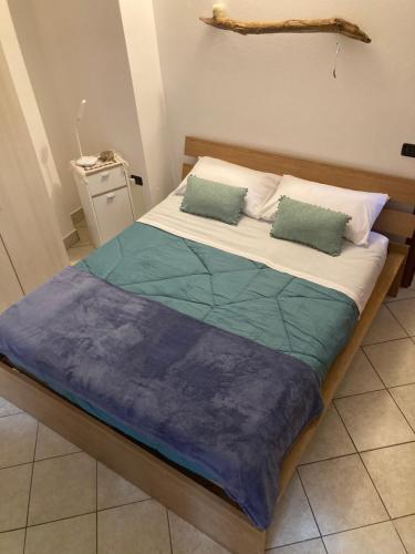 a bed with two pillows on it in a room at House A73 in Lezzeno