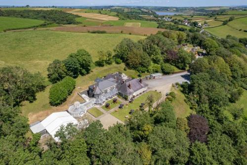 an aerial view of an old mansion in a field at Broadway Country House in Laugharne