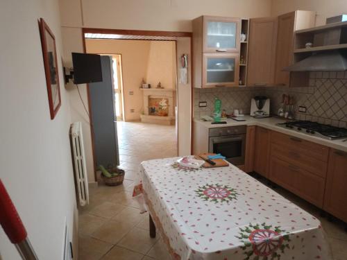 a kitchen with a table with a table cloth on it at Masseria Sant' Anna in Cerreto Sannita