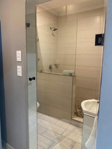 a bathroom with a shower and a toilet at Villa Via Hotel Midrand in Midrand