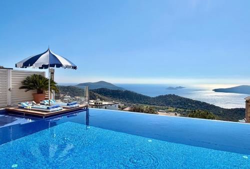 a swimming pool with a view of the ocean at Villa La Mer in Kalkan