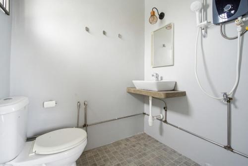 a bathroom with a toilet and a sink at Ruum1 Sugars Houz in Johor Bahru