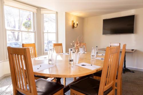 a dining room with a wooden table and chairs at Abbey Fields By Chef & Brewer Collection in Kenilworth