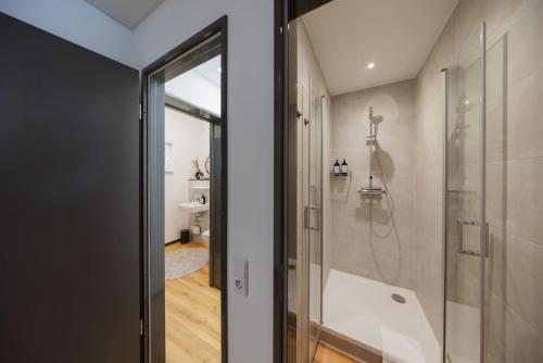 a bathroom with a shower and a glass door at HYGGE HOMES - Apartment 'silva' in Winsen