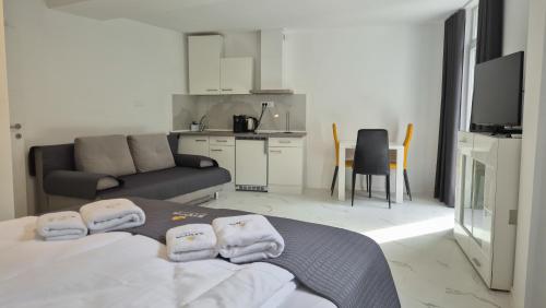 a living room with a bed and a couch at Stopa Art Residence in Šempeter pri Gorici