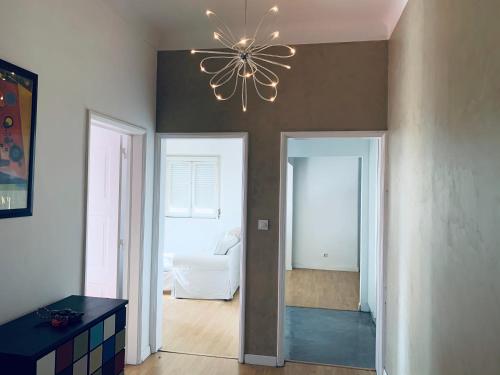 a living room with a chandelier on the ceiling at Gama House Shared Appartment in Lisbon
